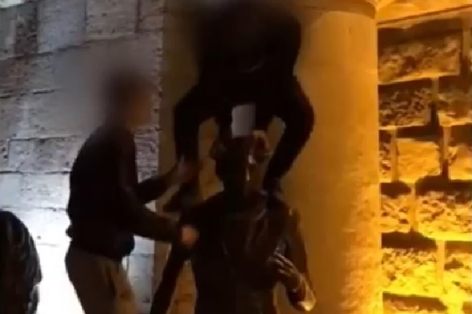Чтобы удобнее было давать пощёчины, молодые люди взобрались на памятник. Фото: кадр видео