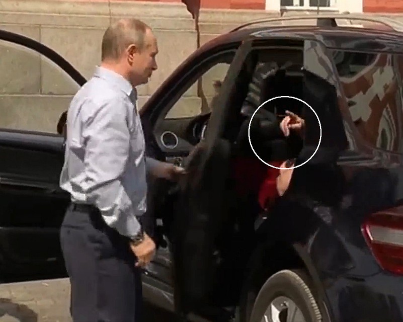 Сидевший сзади сотрудник показывает Путину - вон он, мол, пиджак