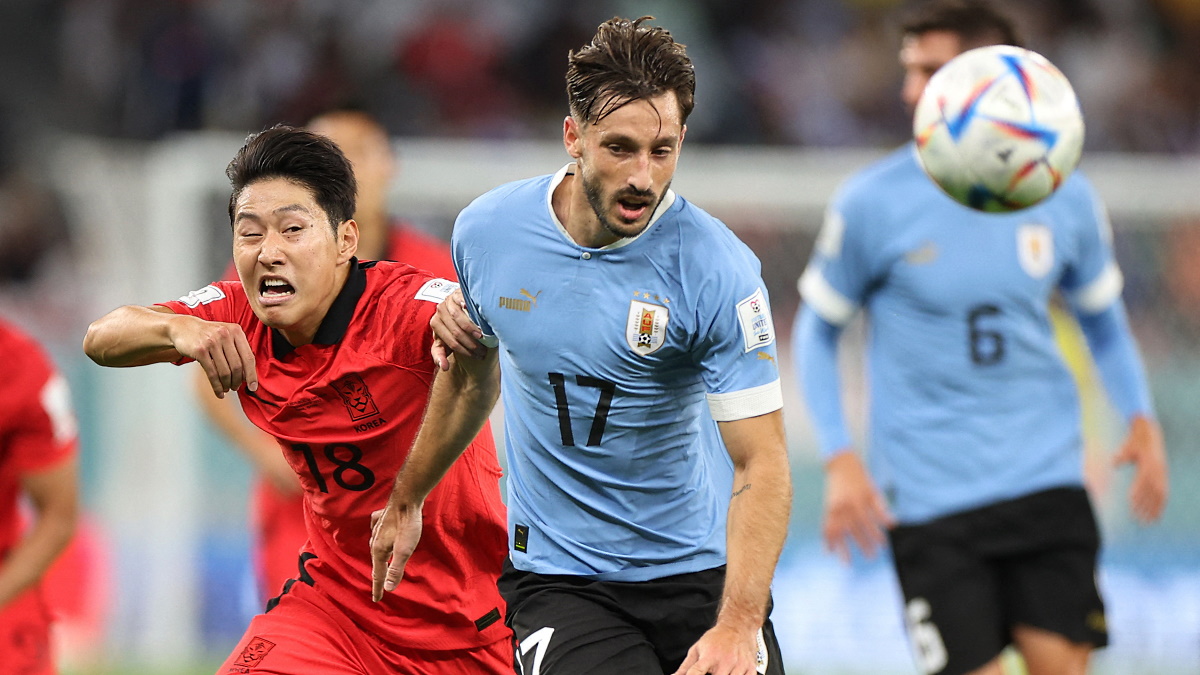 Матиас Вина и Ли Кан-Ин в борьбе за мяч в матче Уругвай - Южная Корея на ЧМ-2022 в Катаре. Фото: REUTERS